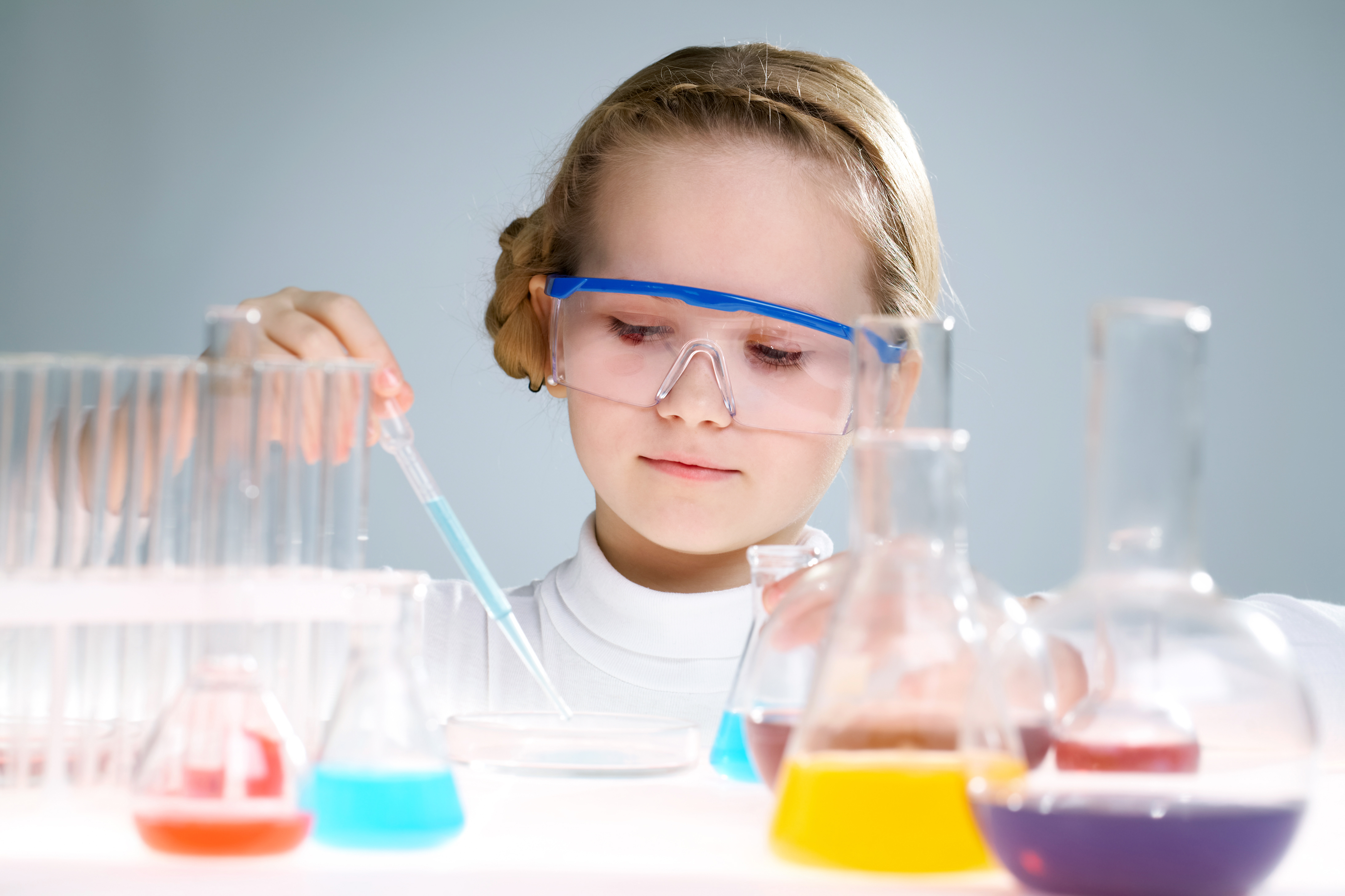 A little girl analyzing chemical liquid